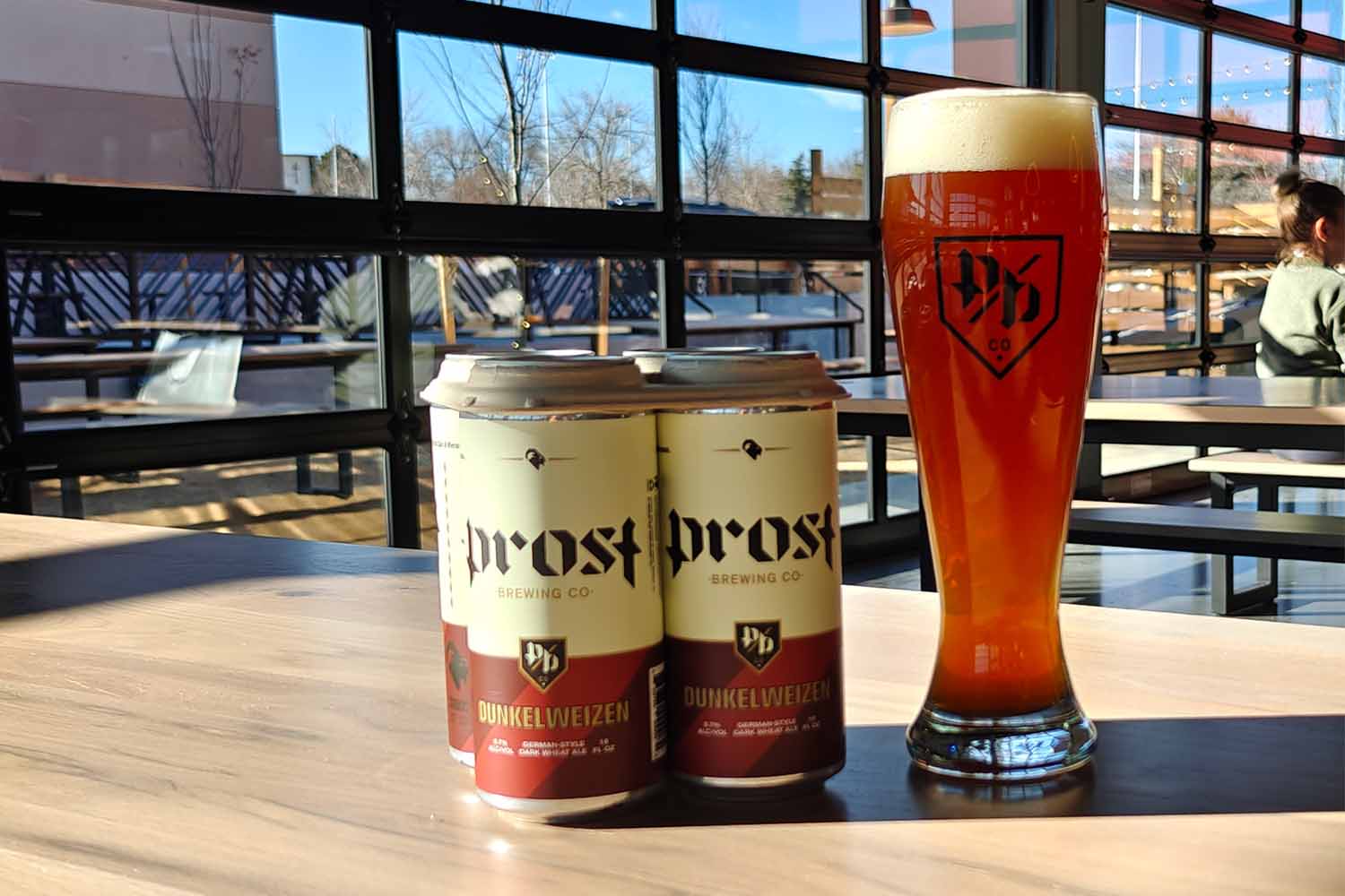 Two cans and one draft of Prost Dunkelweizen