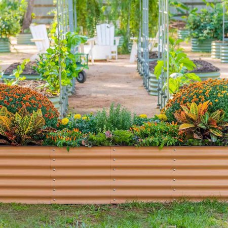 An orange vego garden bed teeming with colorful plants and flowers
