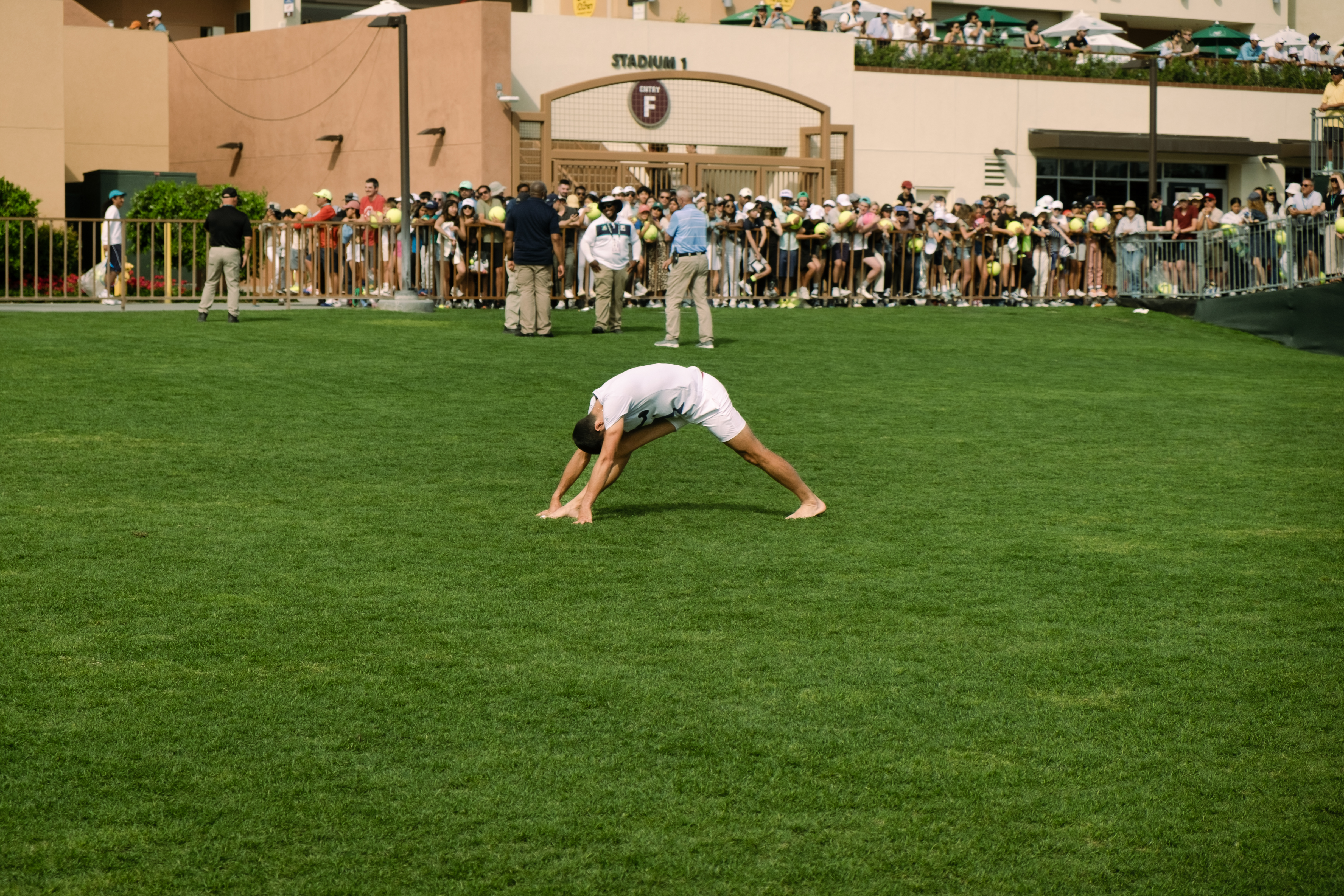 Novak Djokovic stretching on the turf at Indian Wells.