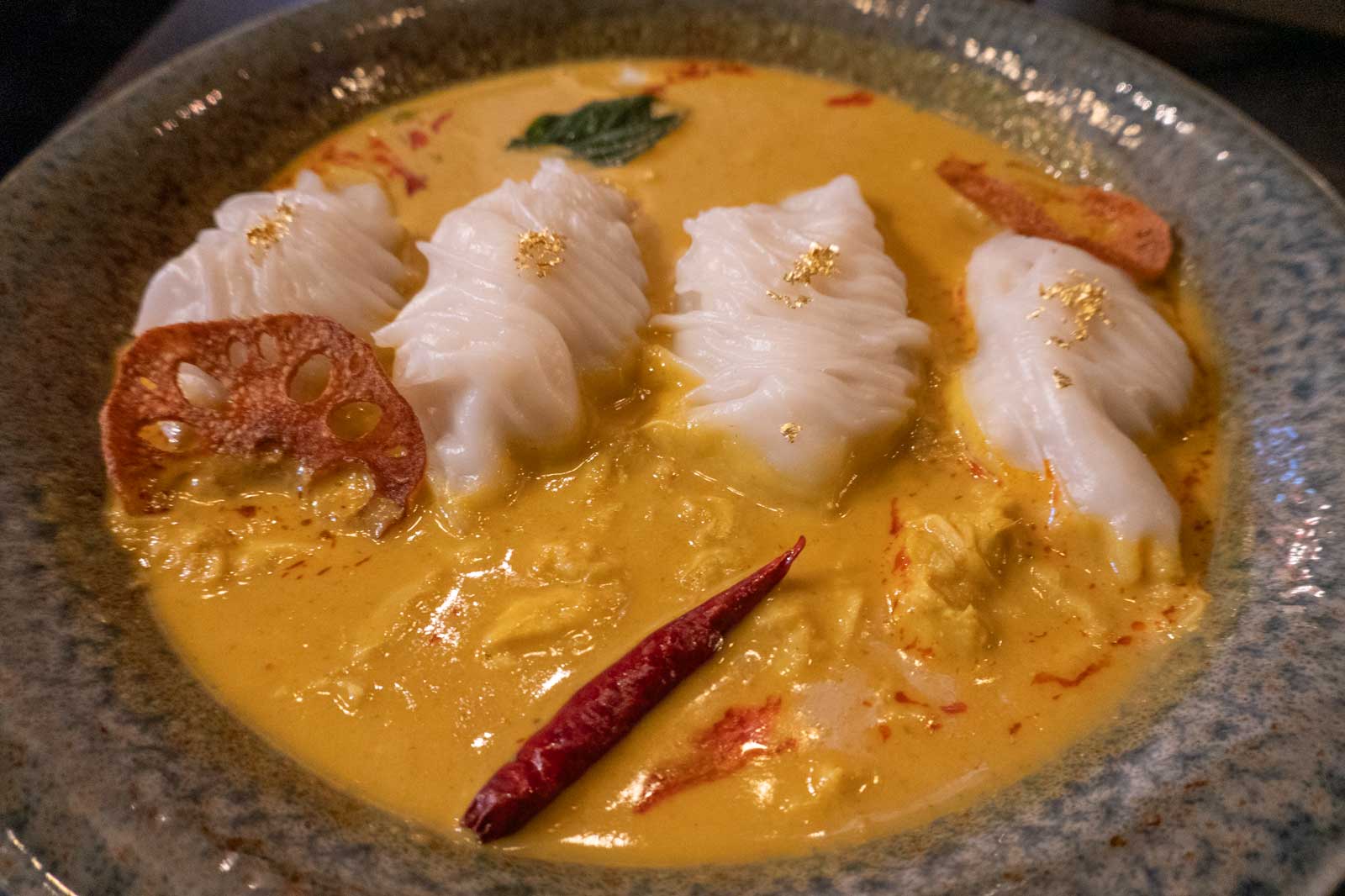 white dumplings in a yellow creamy sauce