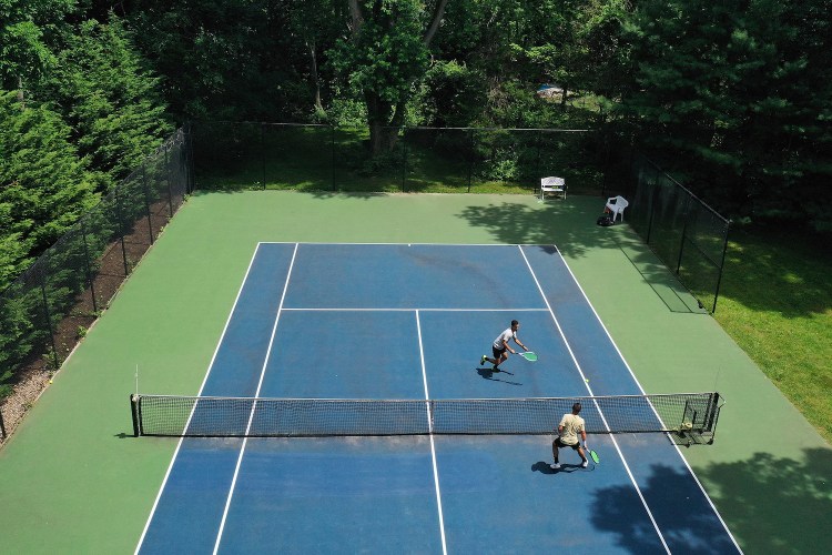 Aerial shot of two men playing tennis.