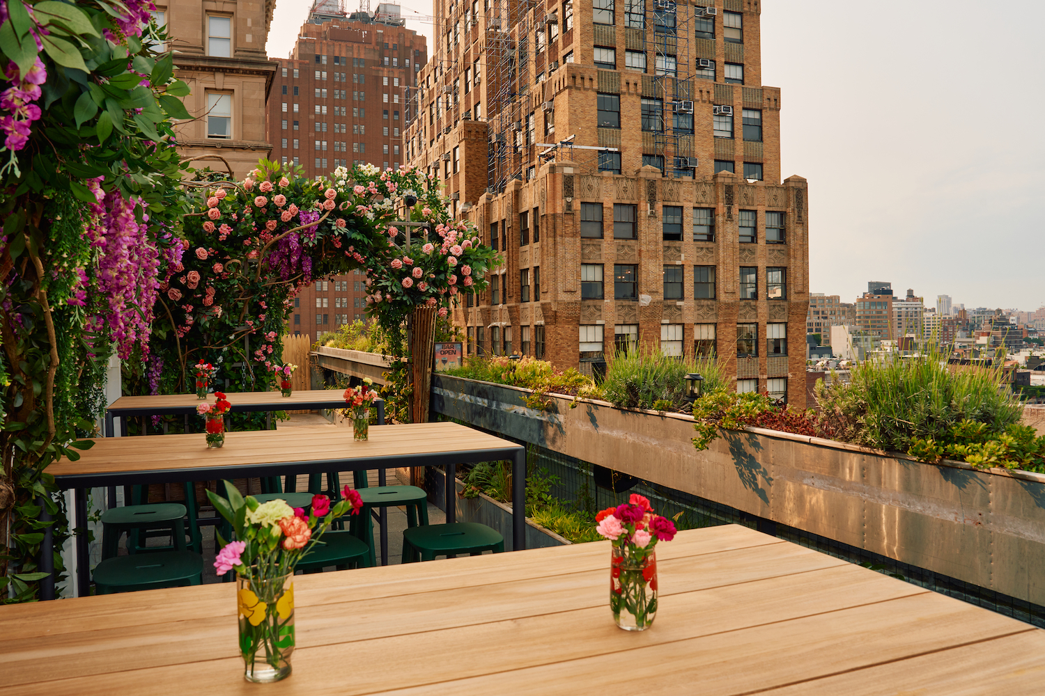The Flower Shop's seating area, bursting with floral decor and overlooking Lower Manhattan