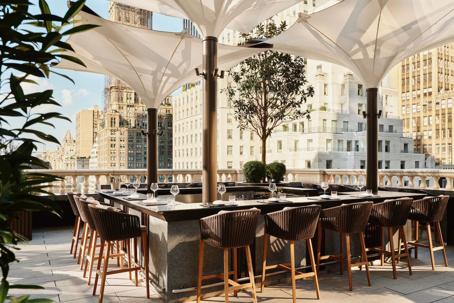 The Aman Terrace's enclosed bar area, set beside a sheltered, outdoor lounge space