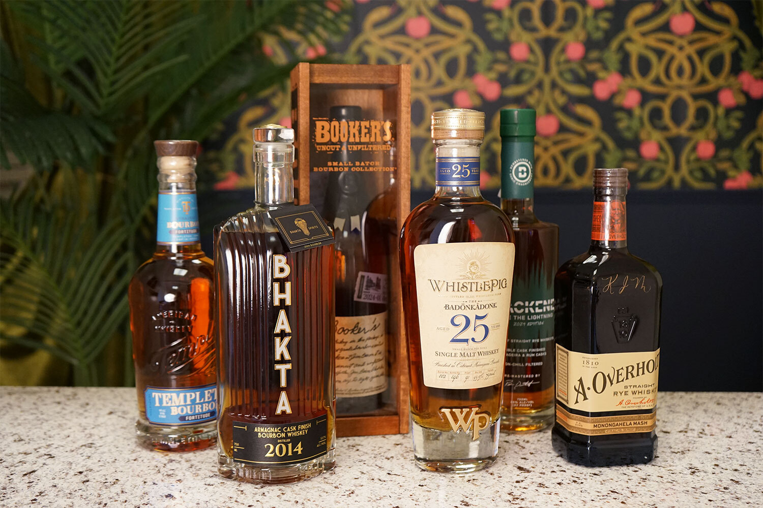 Six bottles of good whiskey coming out in May of 2024 on a bar counter