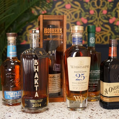 Six bottles of good whiskey coming out in May of 2024 on a bar counter