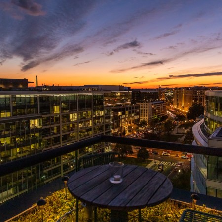 skyline at sunset, round table on terrace