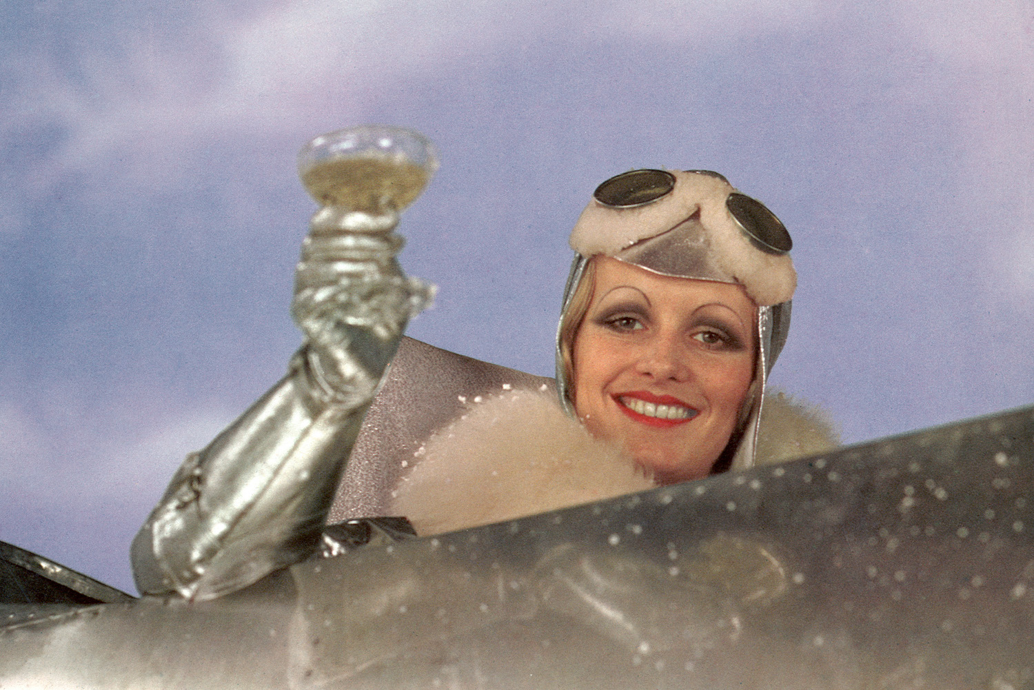 English model and actress Twiggy, as Polly Browne, raises a champagne glass in the cockpit of an aeroplane in a scene from the fim version of Sandy Wilson's musical 'The Boy Friend', directed by Ken Russell, 1971.