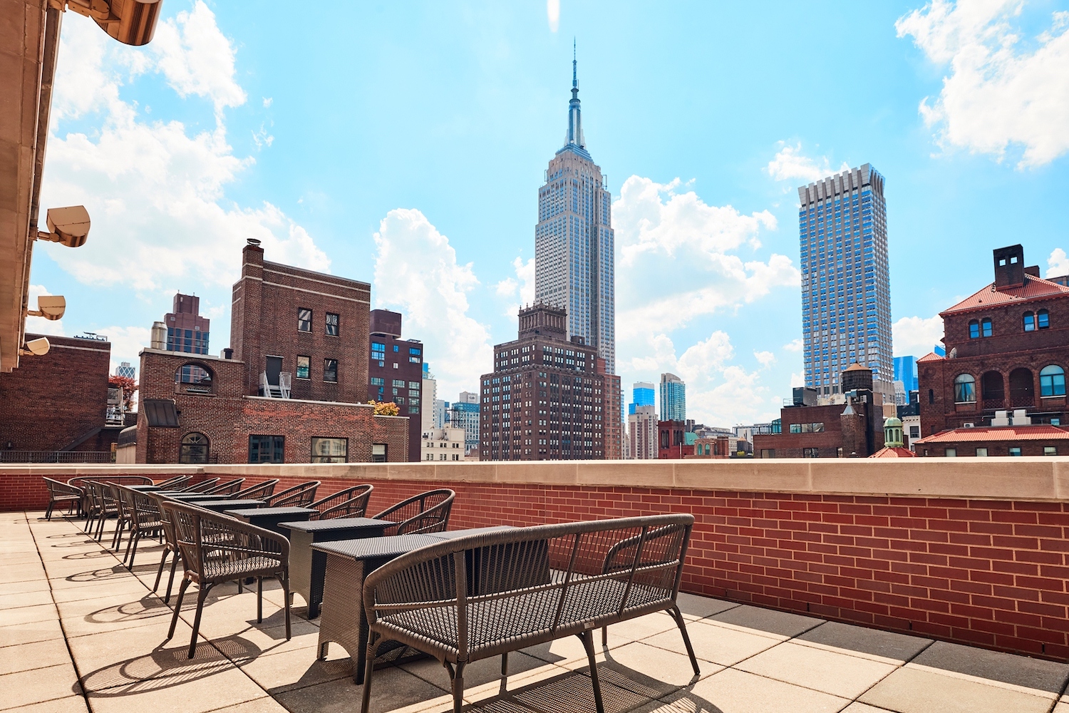 Roof at 66 Park's outdoor seating, featuring a stunning view of the Empire State Building