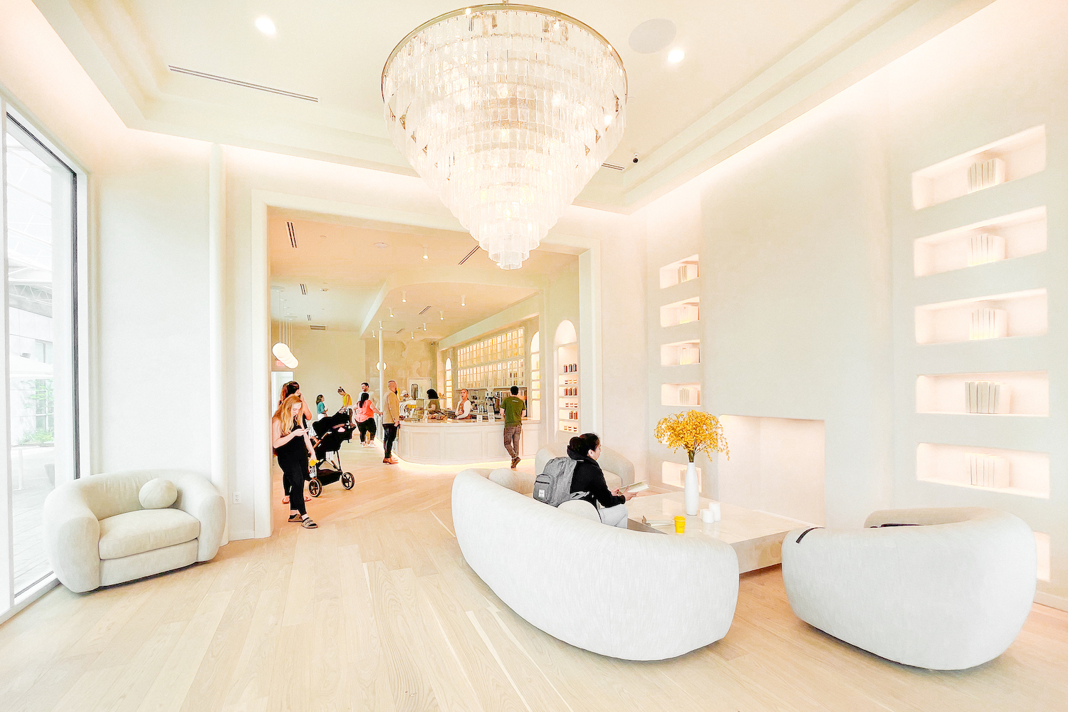 a whitewashed coffee shop with a crystal chandelier
