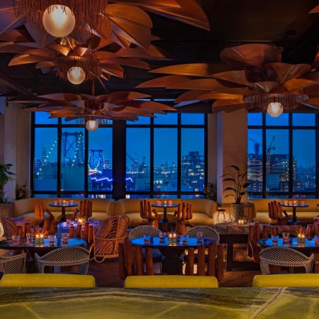 The Manhattan skyline seems to envelope the Moxy Williamsburg's luxurious rooftop lounge
