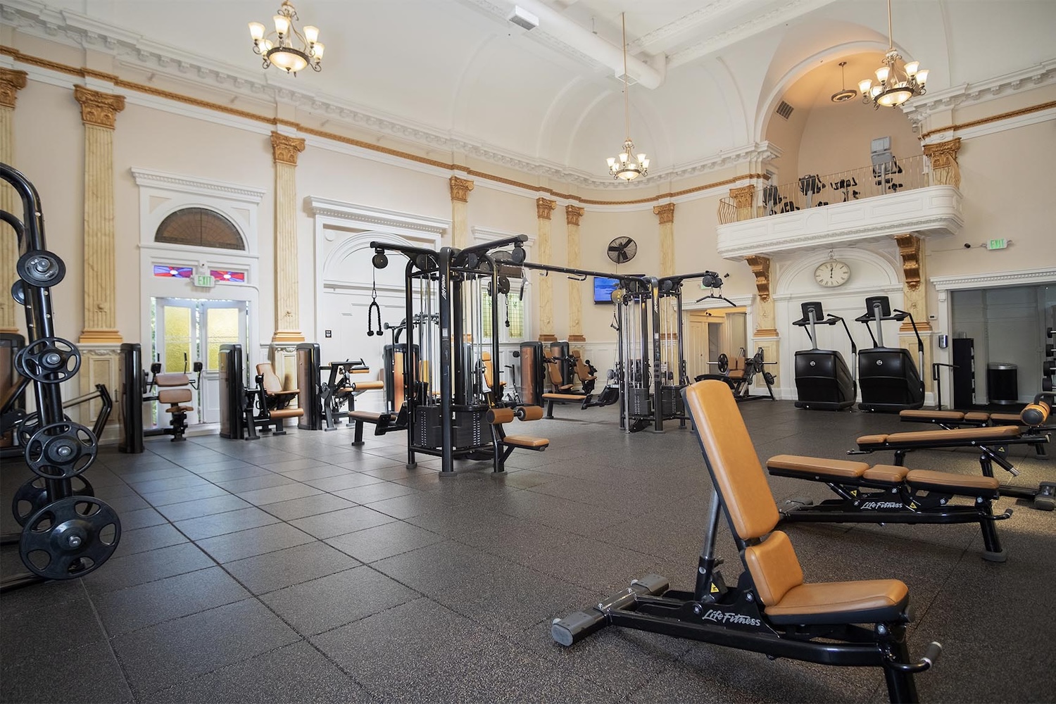 gym equipment, lamps hanging, terraces, columns, and old architecture