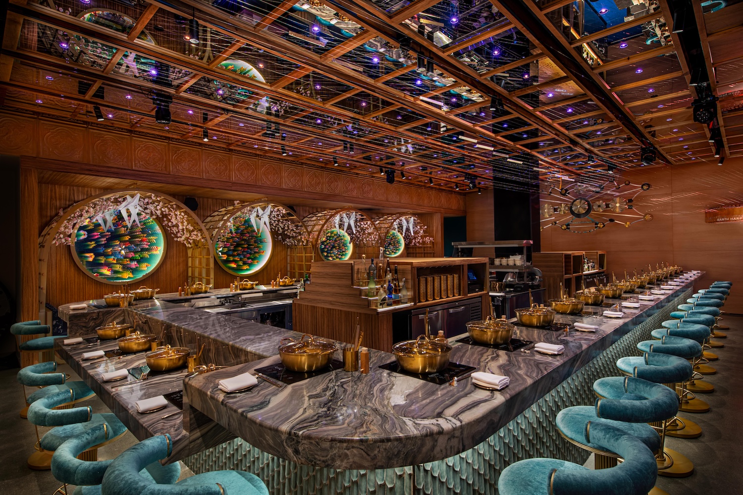 teal velvet stools, marble bar, golden pots, mirrored ceiling