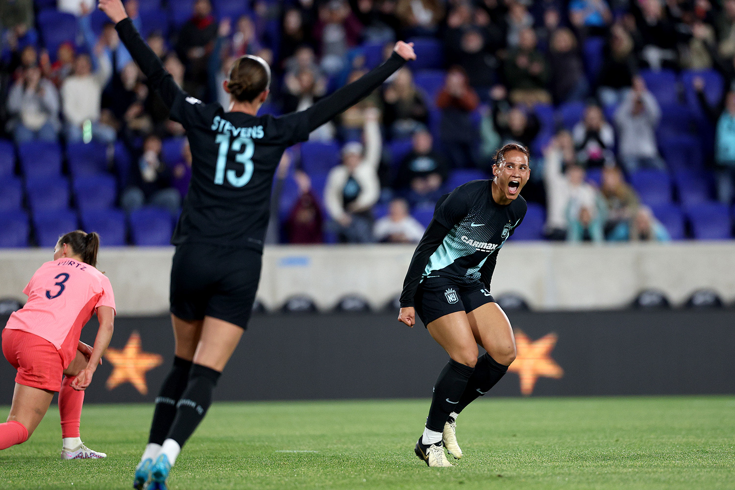 Lynn Williams #10 of the NJ/NY Gotham FC celebrates with teammate Ella Stevens #13 after Williams scored a goal against the North Carolina Courage during the first half at Red Bull Arena on May 04, 2024 in Harrison, New Jersey.