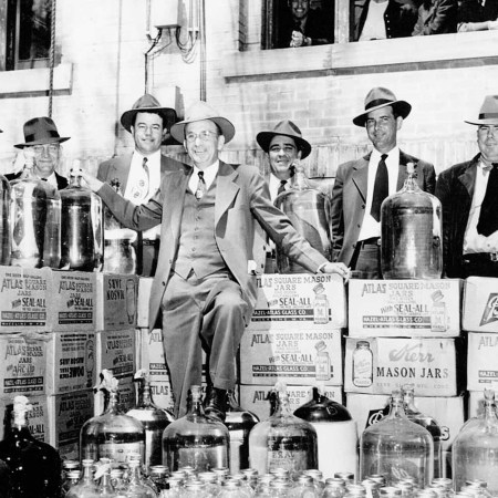 Moonshine bust, group poses with confiscated illegal liquor outside Johnson County Courthouse, 1951. Mason jars were used -- but our writer thinks the modern-day use of Mason jars is overrated.
