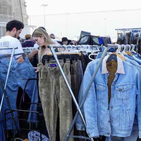 denim on racks, woman looking through