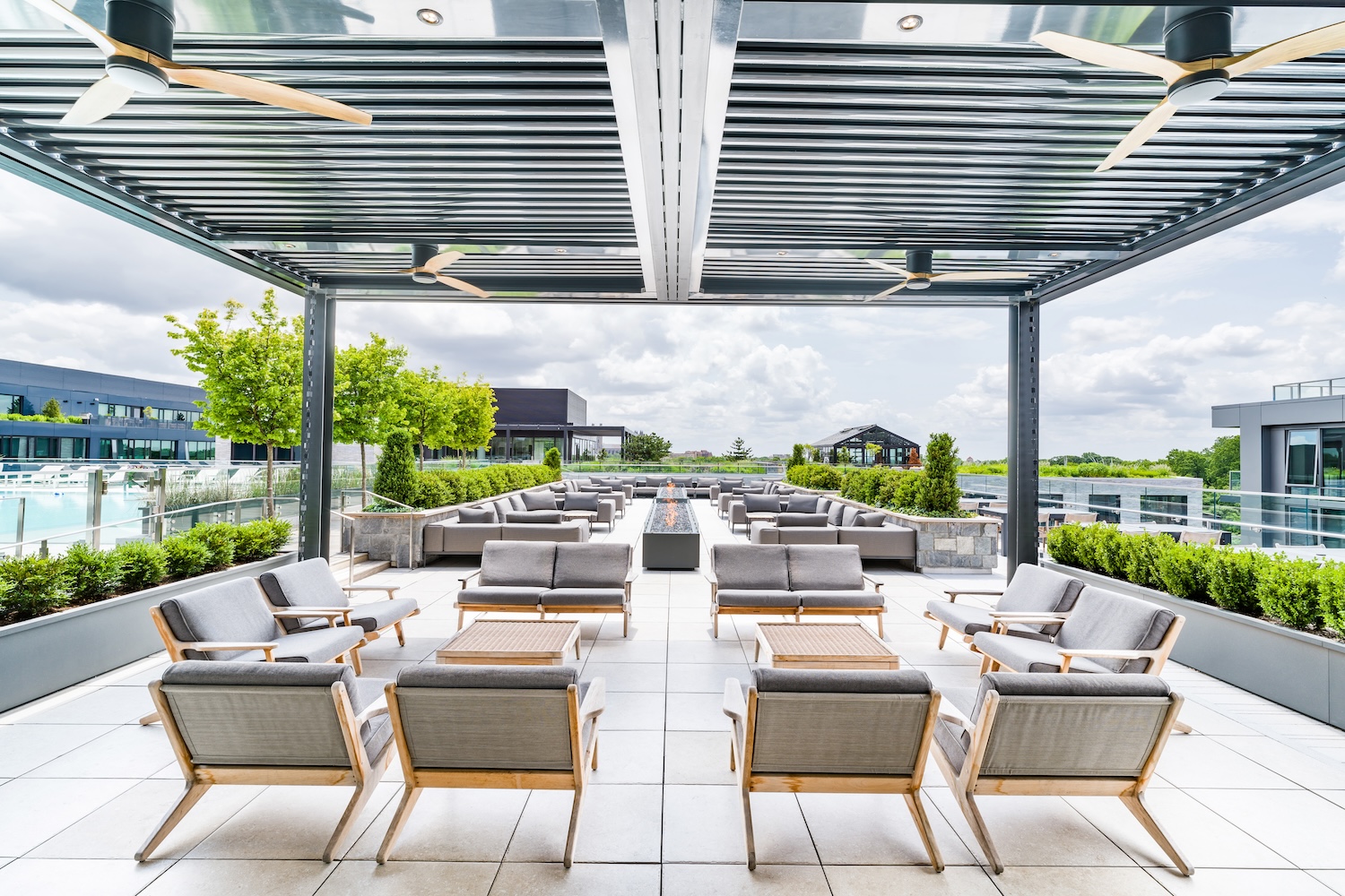 gray lounge chairs, trees and grass in the background