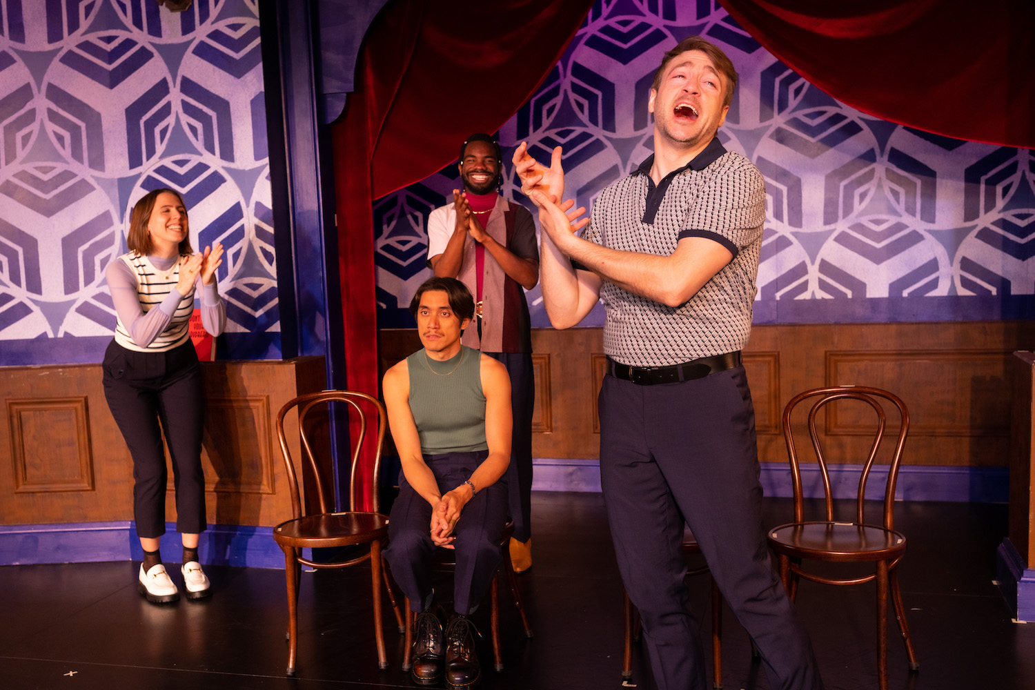 A group of people perform on a stage.