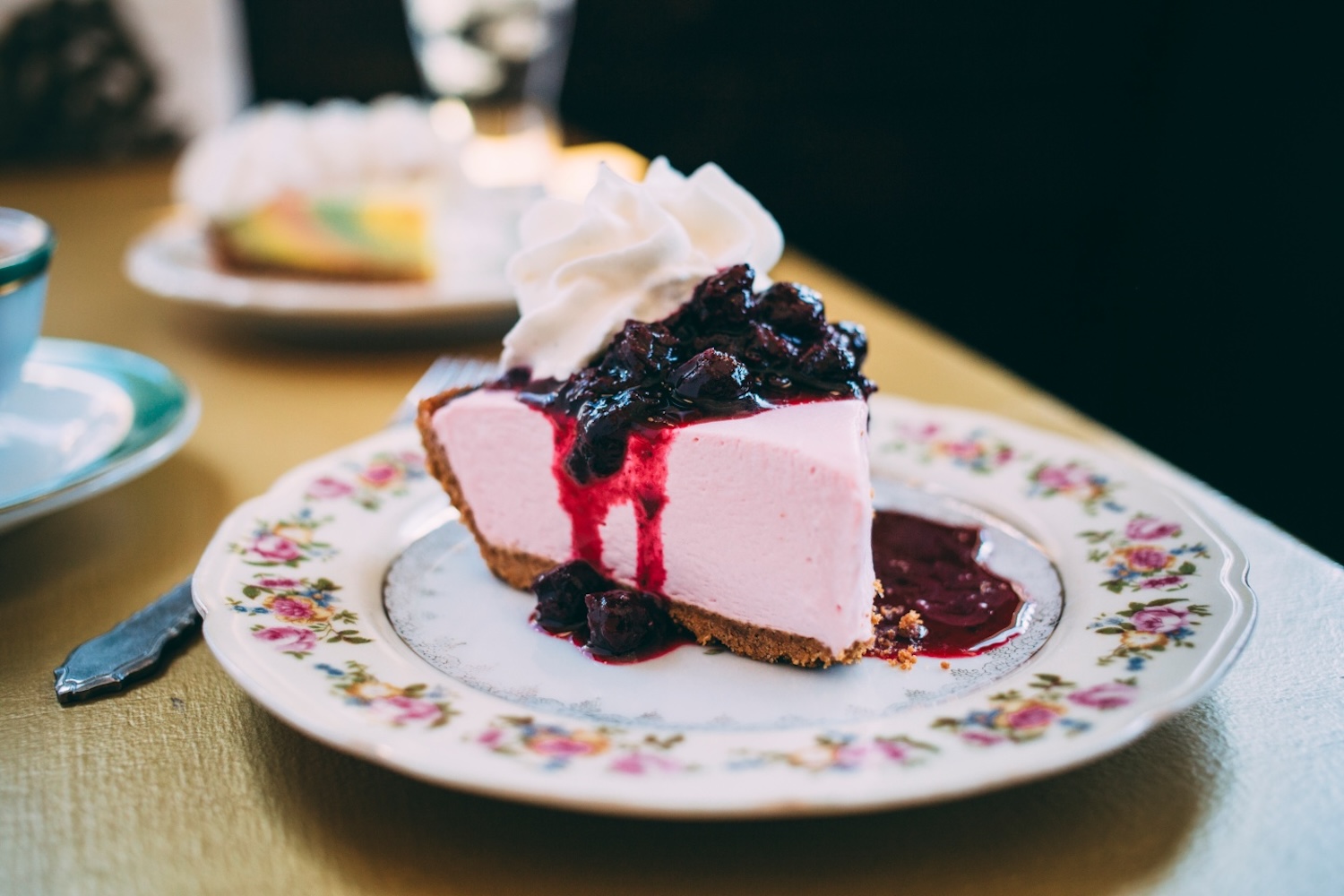 pink key lime pie with whipped cream and berries