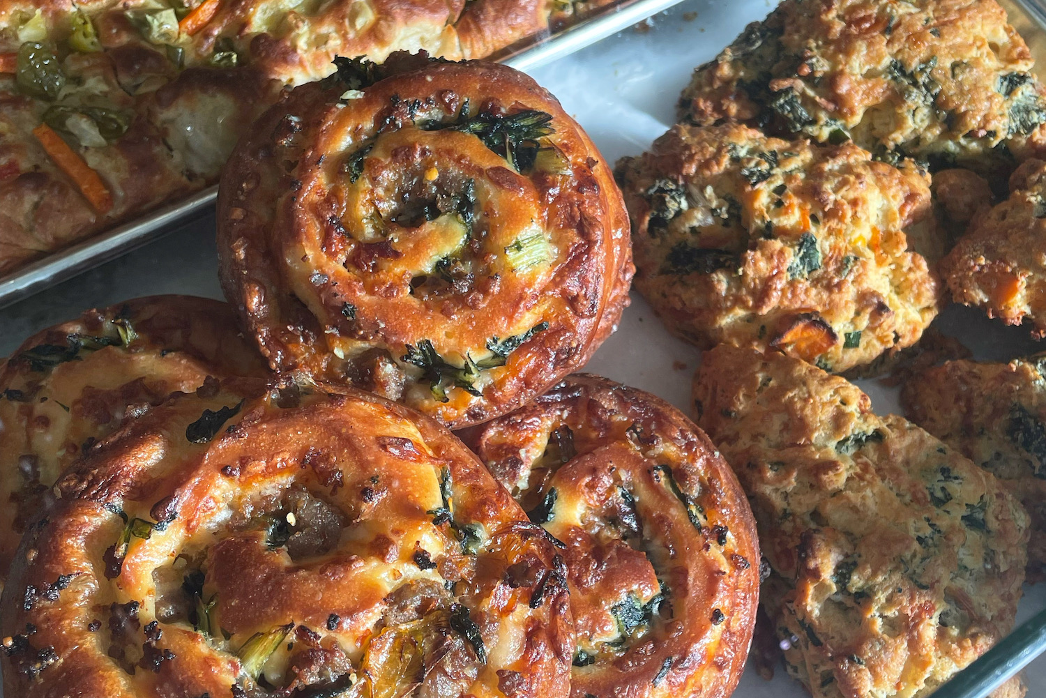 three kinds of savory pastries on an aluminum baking sheet