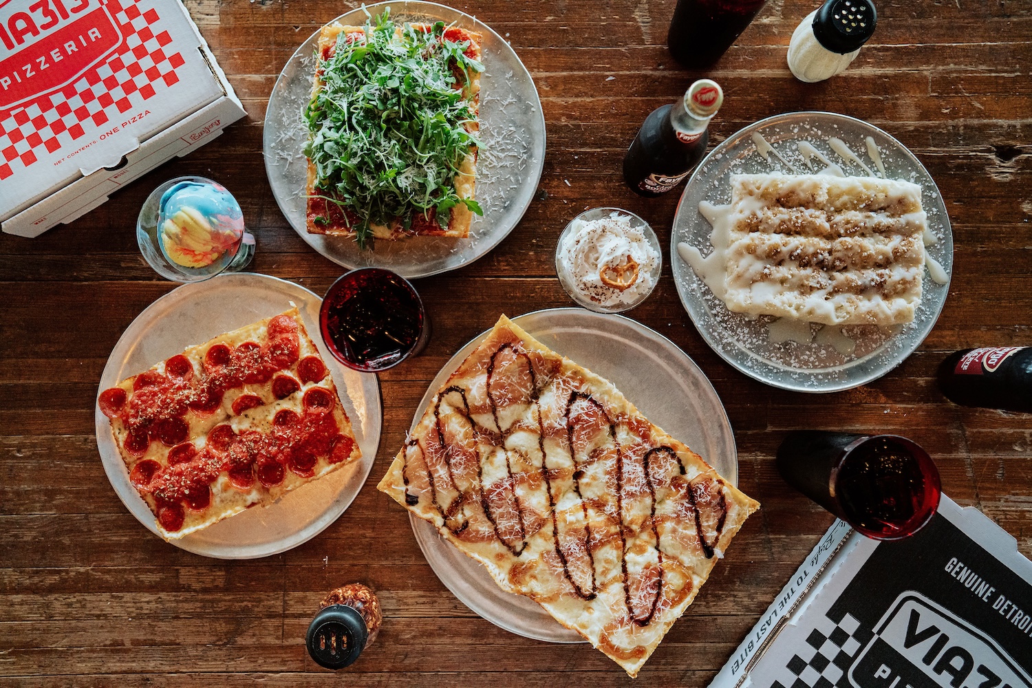 multiple pizzas laid out on different plates
