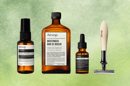 Aēsop products on a green watercolor background