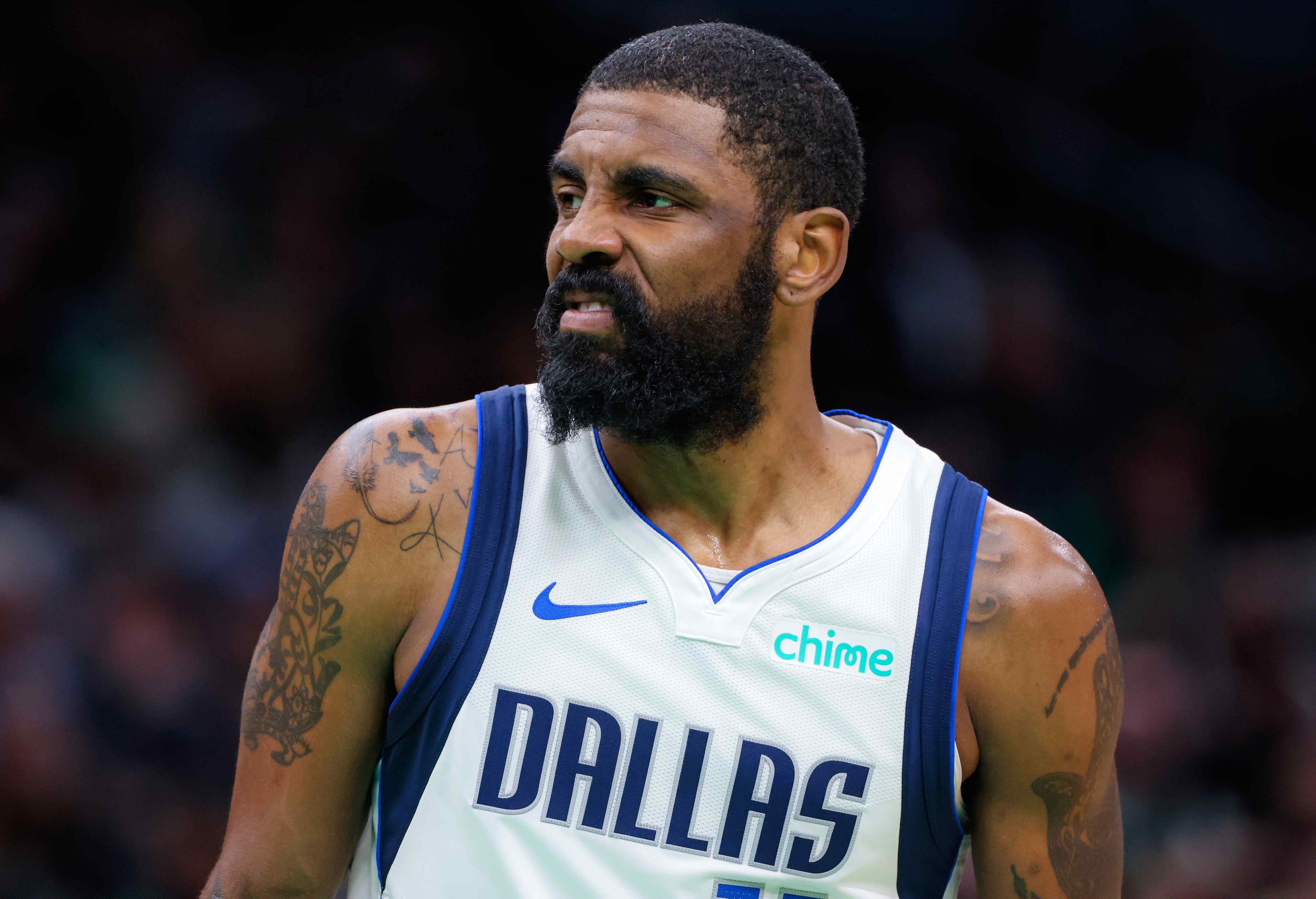Dallas Mavericks guard Kyrie Irving makes a face.