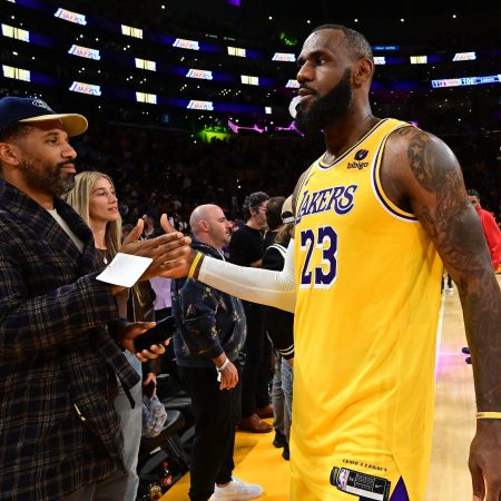 Maverick Carter high-fives LeBron James.