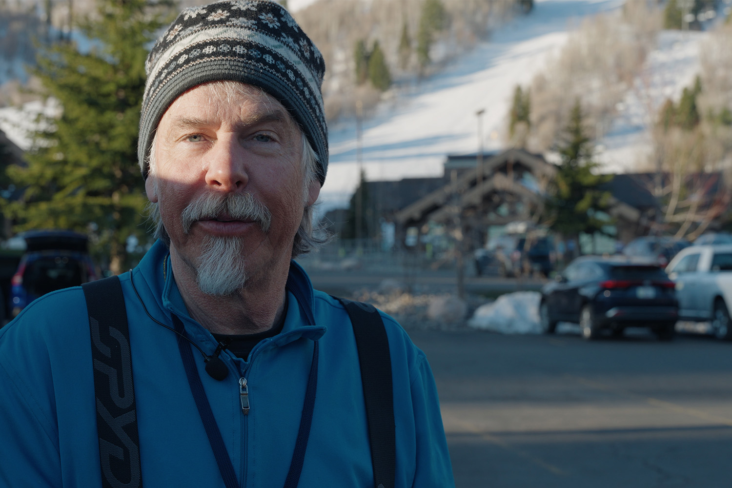 A profile shot of Racer Tom, wearing a grey goatee and a ski beanie.