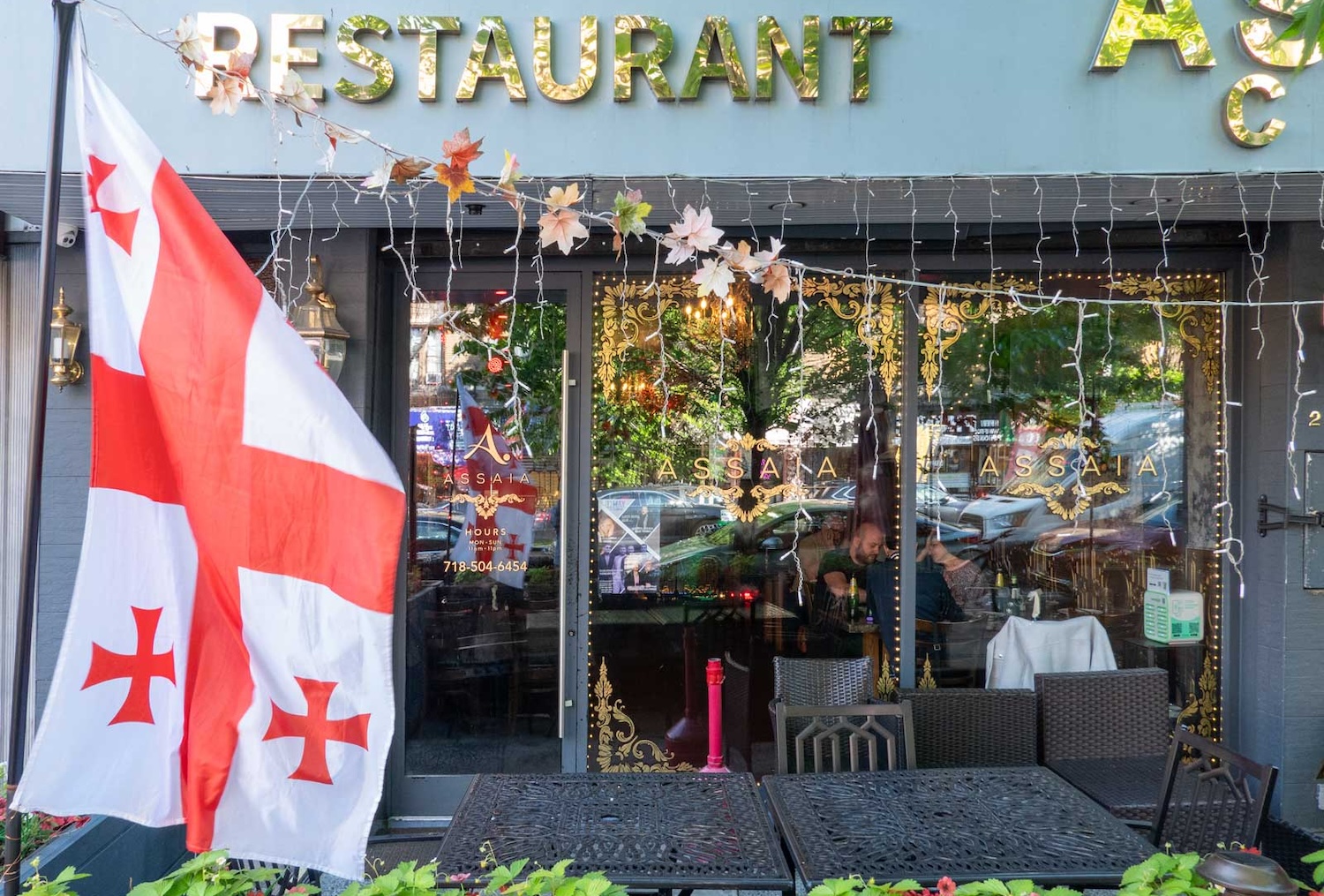 The front face and patio seating area of ASSAIA in Brooklyn's Bath Beach