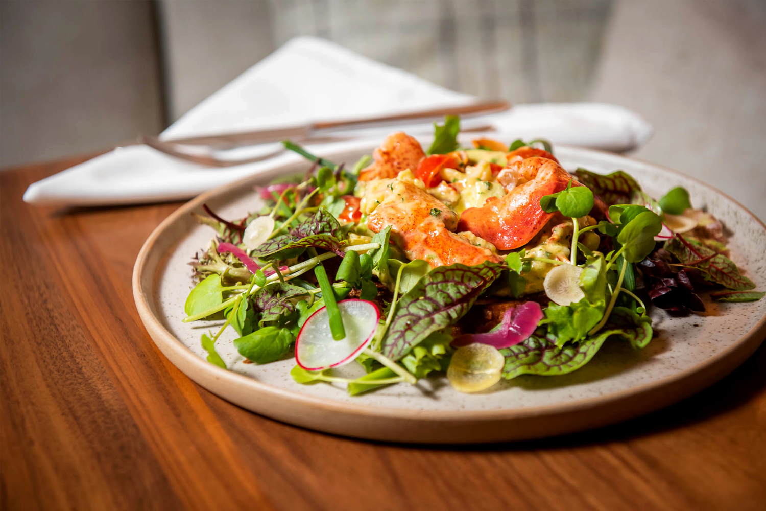 a colorful salad on a stoneware plate