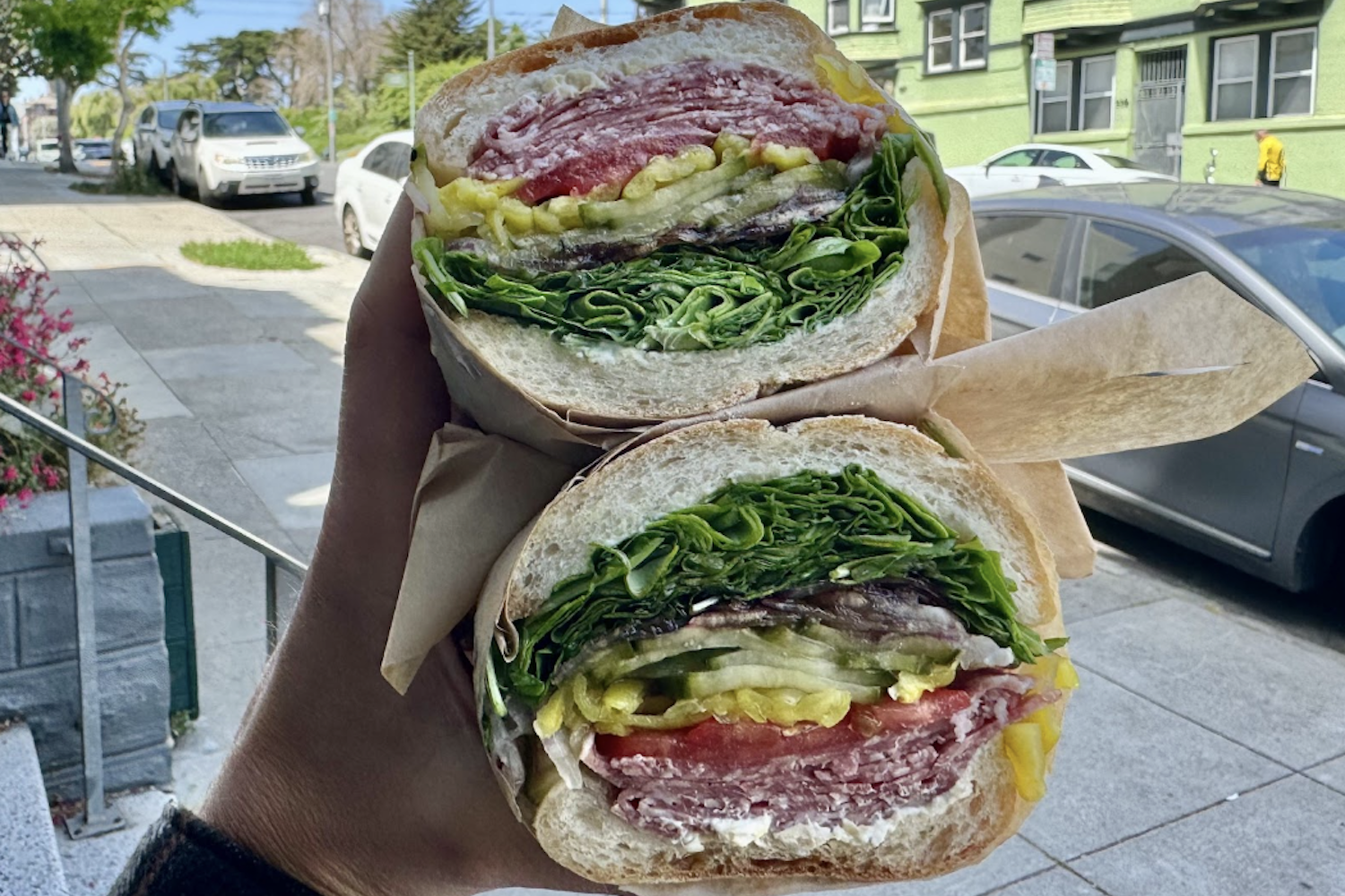 Lucinda's "Soppressata" with arugula, red onion, pickled cucumber, balsamic reduction, pepperoncini, tomato and  artichoke cream cheese