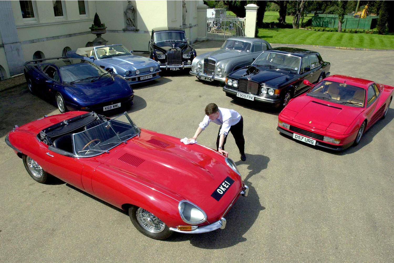 Christie's Car Specialist Rupert Banner polishes the bonnet of rock star Elton John's 1965 Jaguar E Type 4.2 Roadster at Stoke Park Club in Buckinghamshire