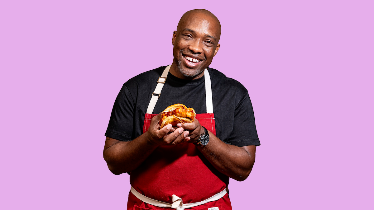 Chef Rahman "Rock" Harper holding Queen Mother's signature fried chicken sandwich