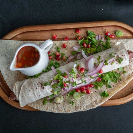 X Factory's signature kebab, featuring beef and pork wrapped in a thin layer of bread and topped with onion, pomegranate and cilantro