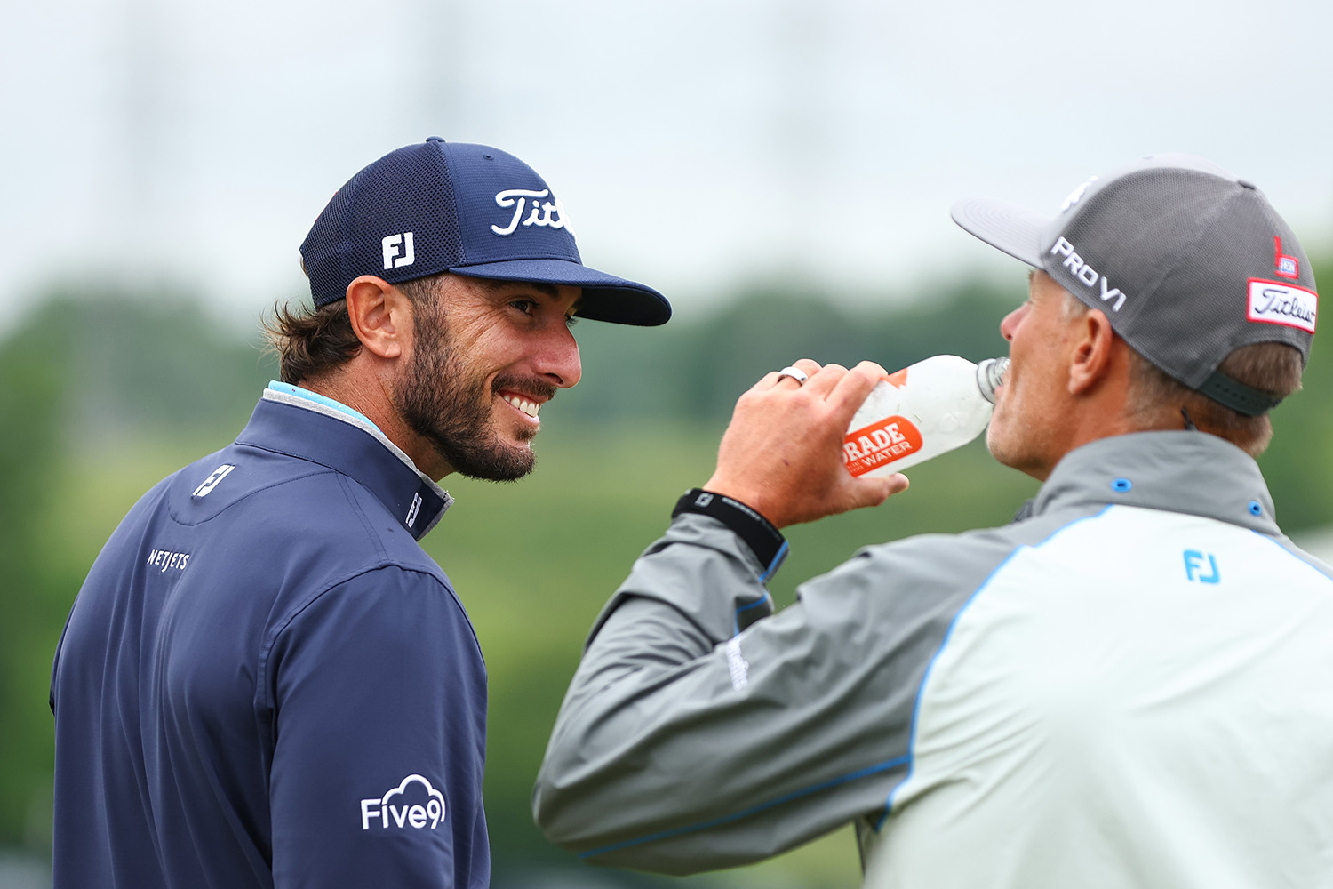 Max Homa smiling at a friend during a golf tournament.