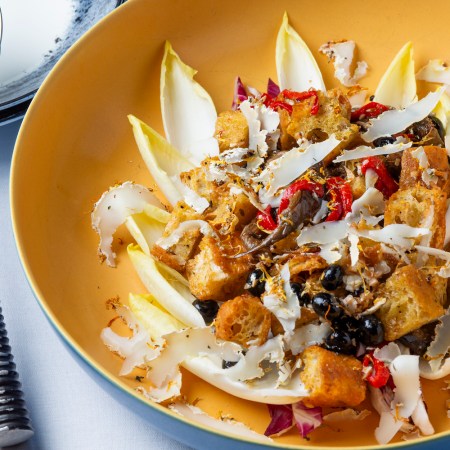 A radicchio panzanella salad with blueberries and goat cheese in a yellow bowl, from Chef Greg Wade of Publican Quality Bread
