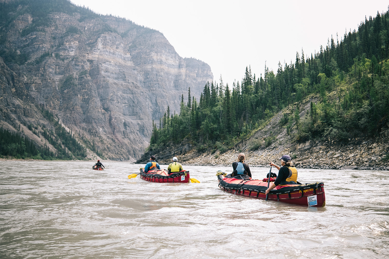 A view of other canoes paddling along the river.