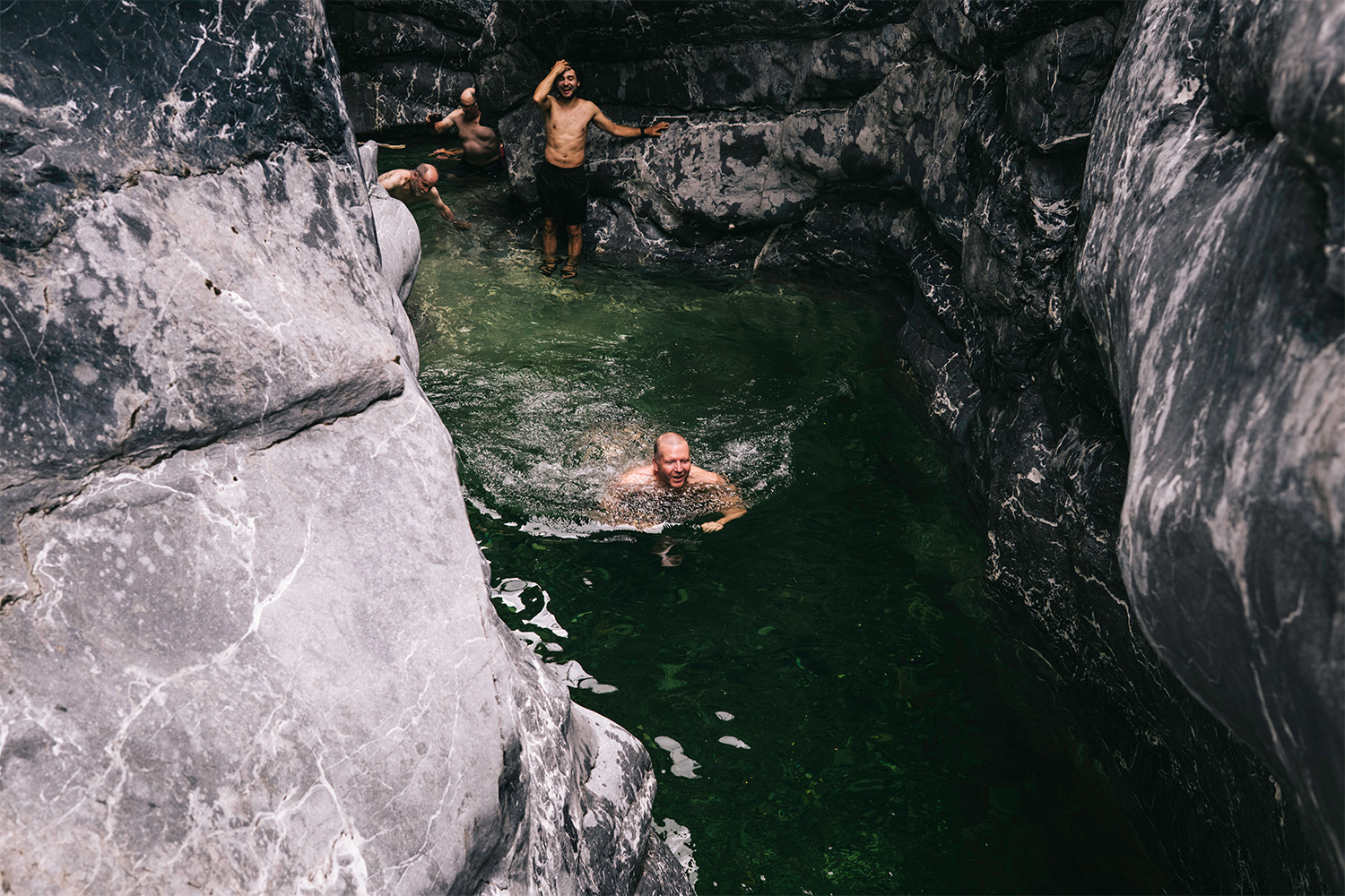 The members of the group go for a swim in the canyon.