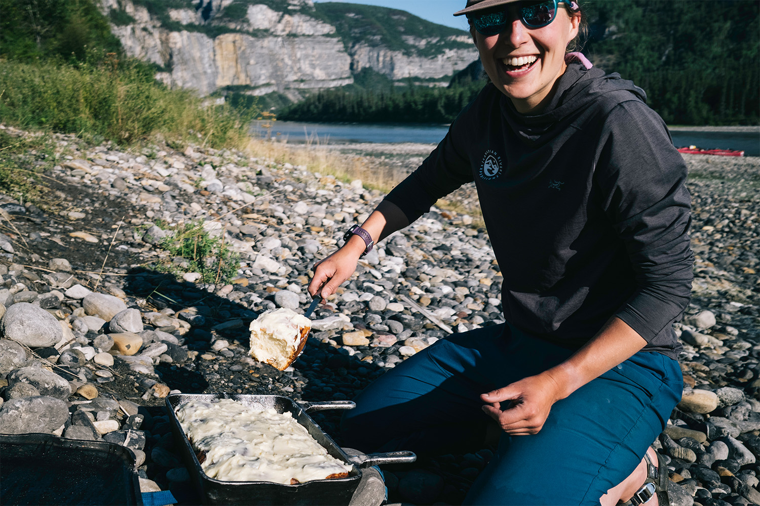 Another member of the trip hods up a a tray of cinnamon rolls.