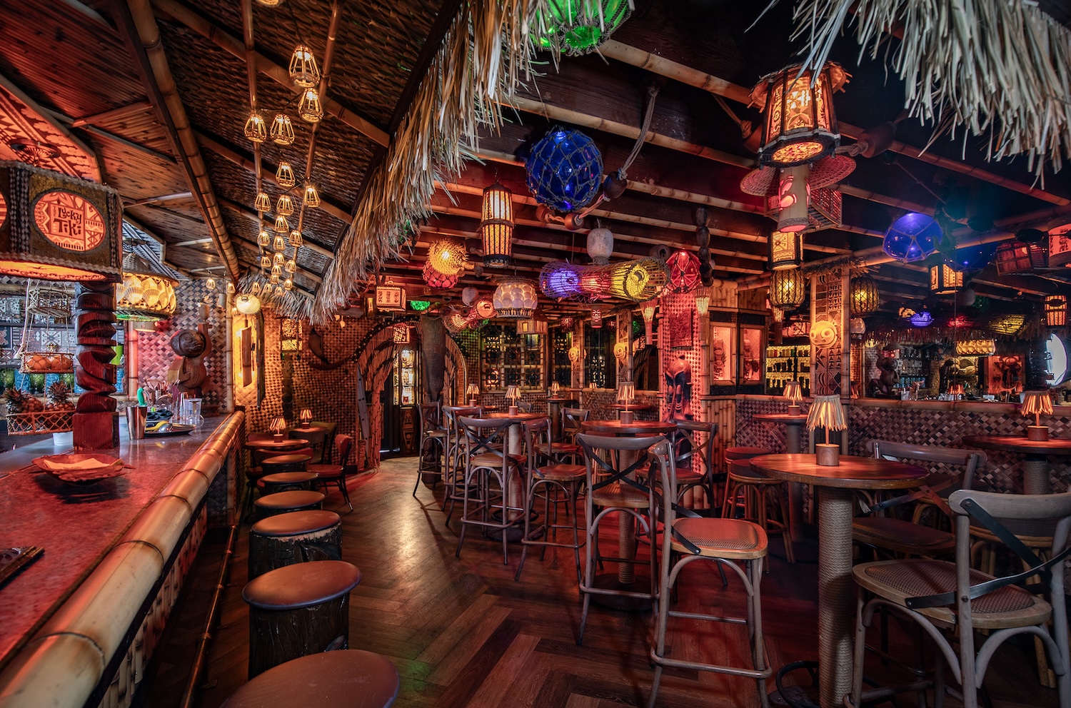 Interior of Lucky Tiki, decorated in bamboo decor and colorful lighting