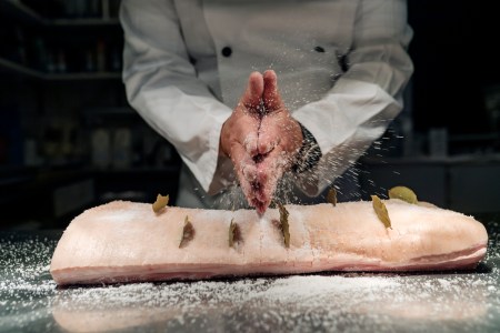 A pro chef salts the Danish dish flæskesteg, a celebratory roast pork
