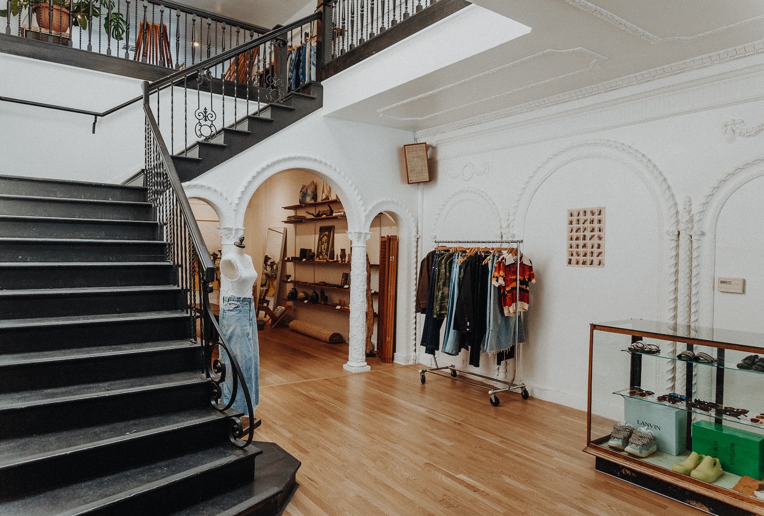 Stairwell and clothing racks inside of ReLove, a San Francisco-based thrift store.