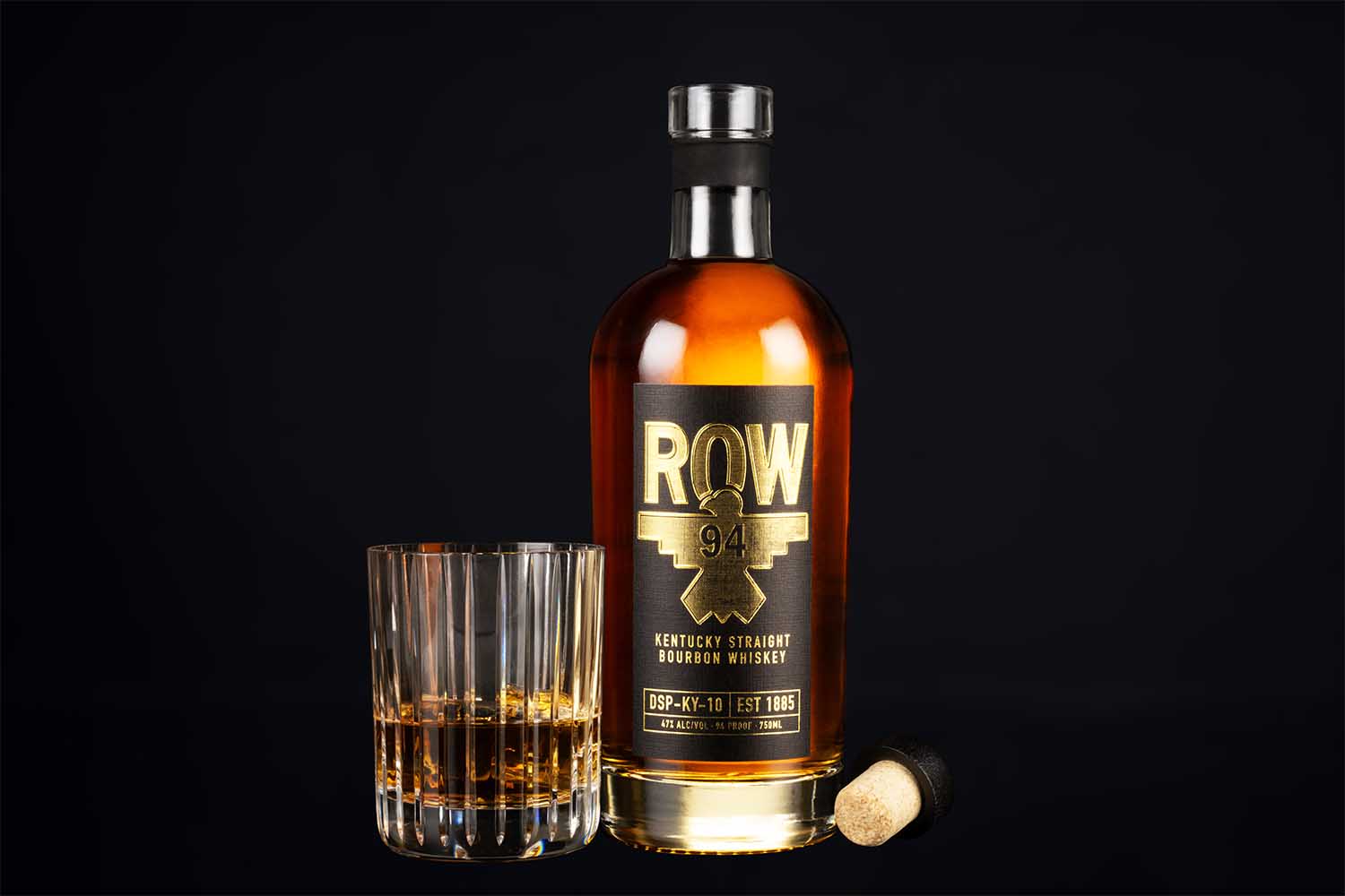 A glass and a bottle of ROW 94 bourbon
