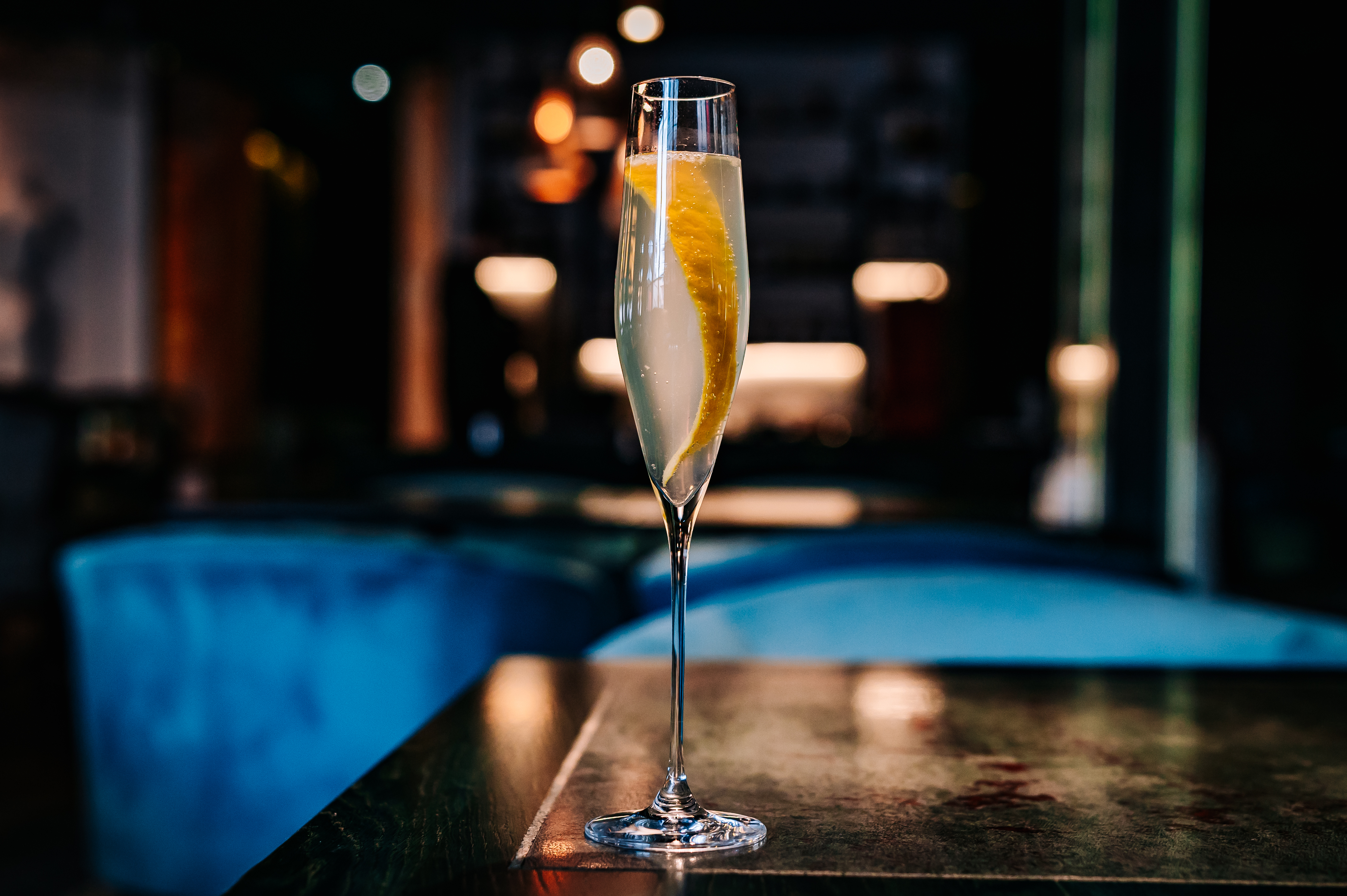 French 75 cocktail in a champagne flute on table
