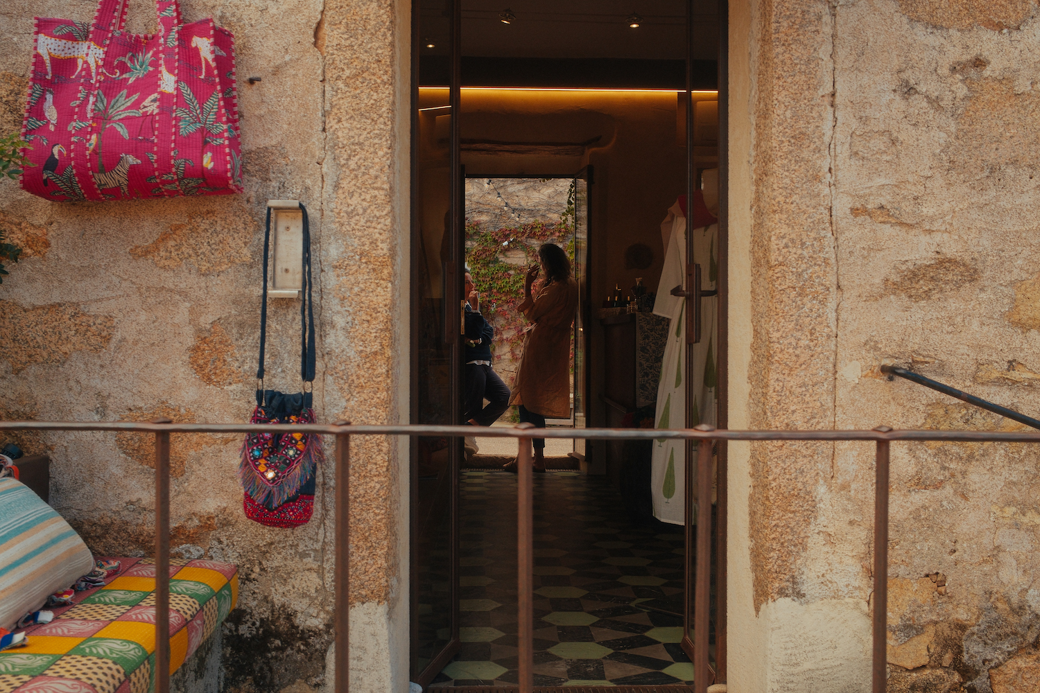 peering through a shop door seeing two women talking