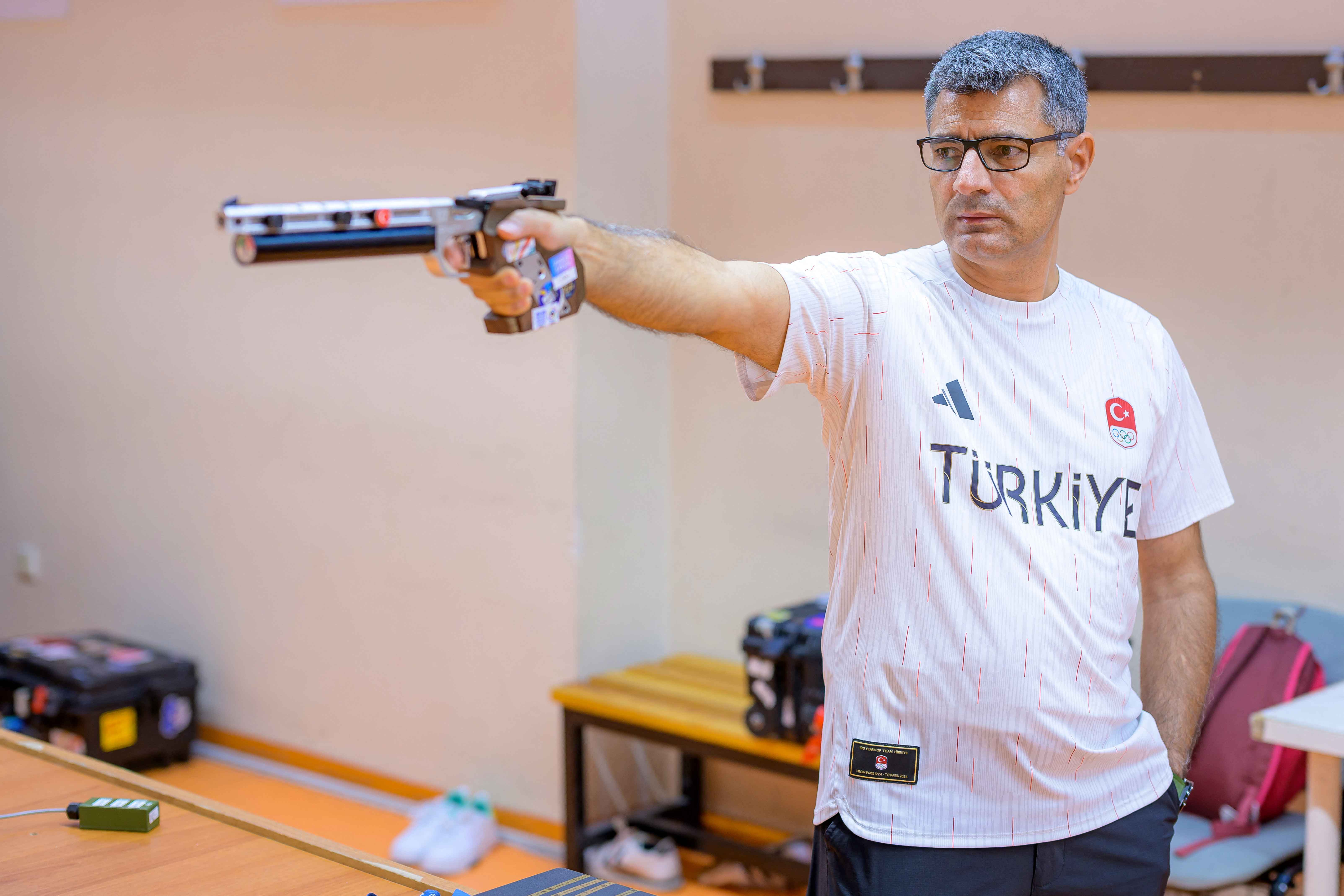 Olympic silver medalist shooter Yusuf Dikec who shoots in the mixed team 10-metre air pistol category in the 2024 Paris Olympic Games and won the silver medal poses for a photograph, in Ankara on August 9, 2024. Shots of the Turkish athlete Yusuf Dikec cocking his pistol with nonchalance, his silver medal in Paris earned with his off hand in his pocket and no protective glasses or headphones, went viral around the world. But in spite of his newfound internet fame, Dikec insisted that he was "the same man". (Photo by Yasin AKGUL / AFP) (Photo by YASIN AKGUL/AFP via Getty Images)