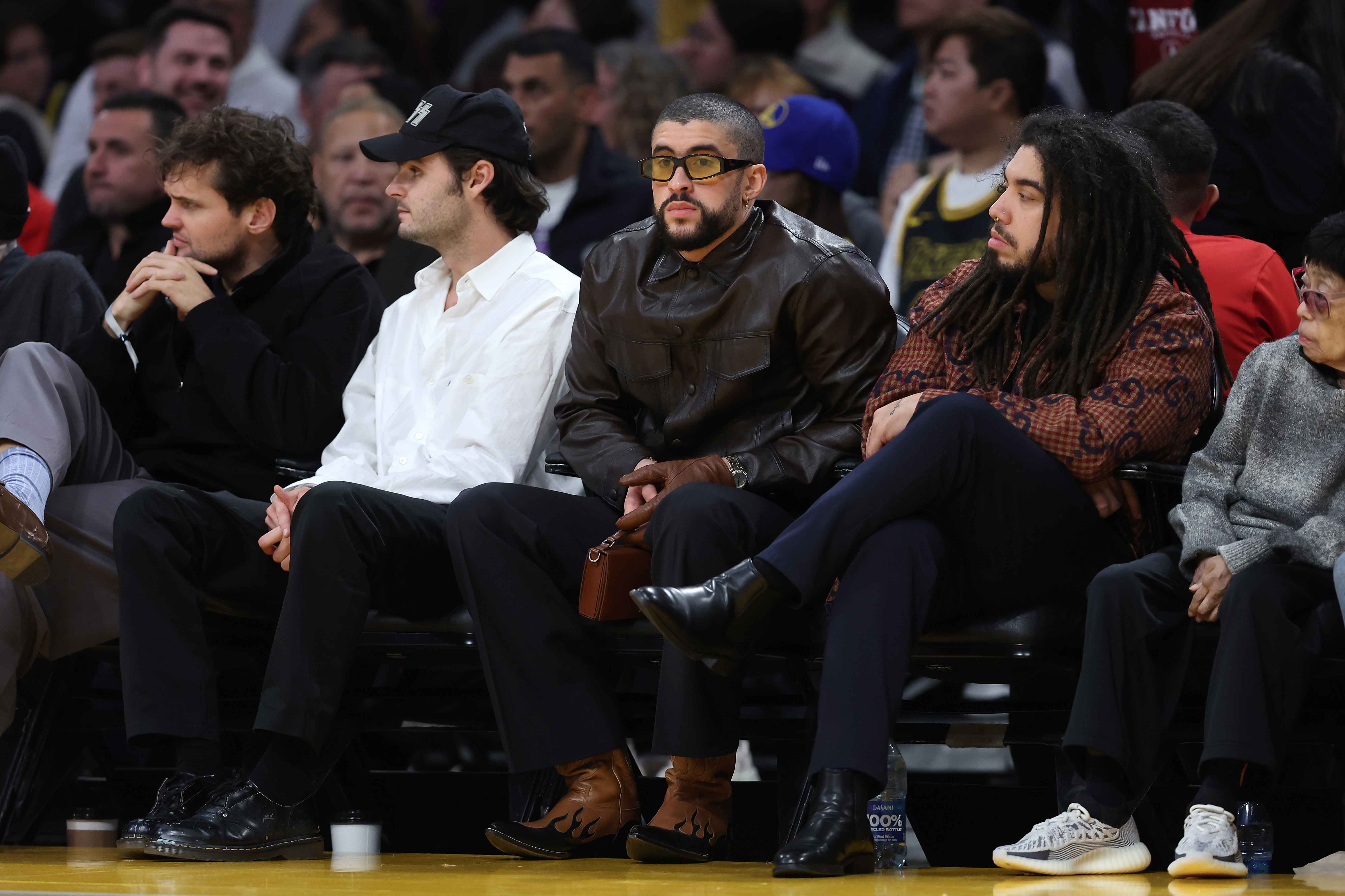 LOS ANGELES, CALIFORNIA - MARCH 16: Musician Bad Bunny looks on from the front row during the second half of a game between the Golden State Warriors and the Los Angeles Lakers at Crypto.com Arena on March 16, 2024 in Los Angeles, California. (Photo by Sean M. Haffey/Getty Images)