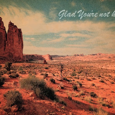 a vintage desert postcard that says glad you're not here