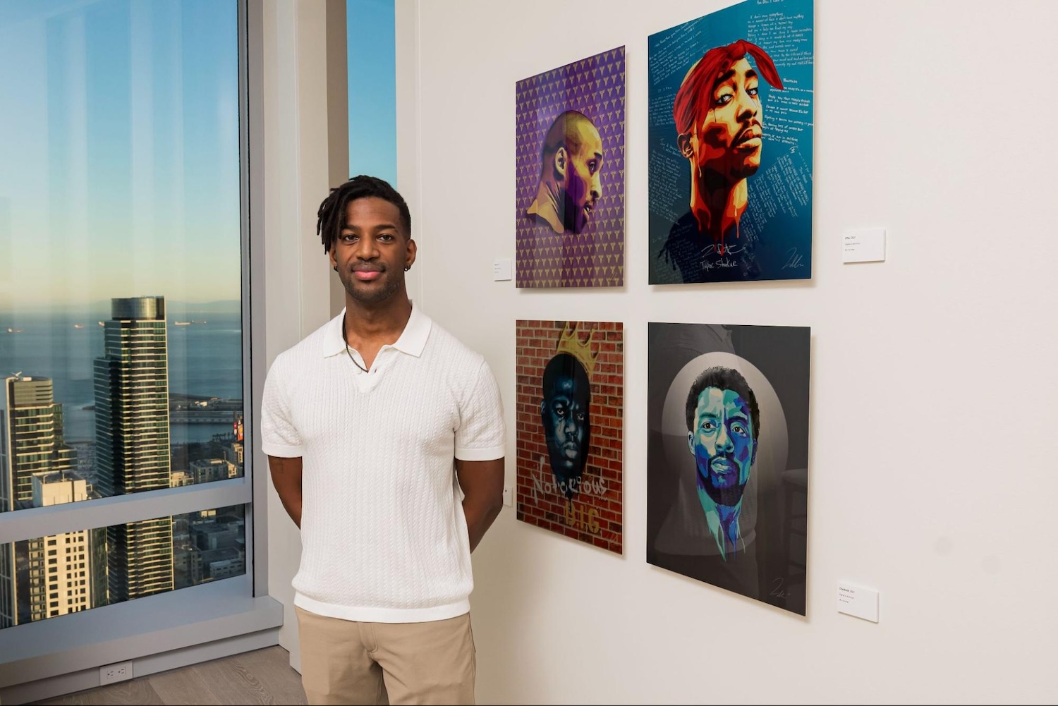 Tyler Willis stands with portraits