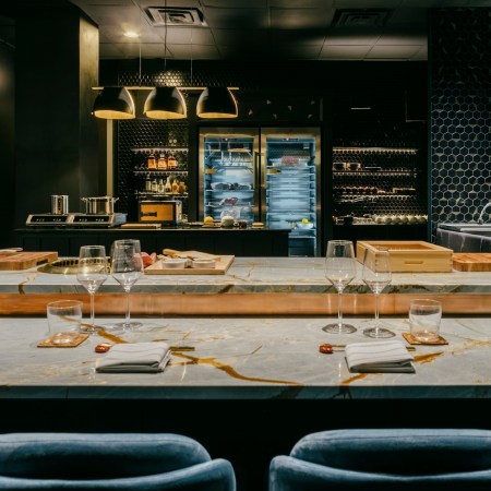 Marble bar with tall blue bar stools at omakase restaurant Bonyeon in Chicago